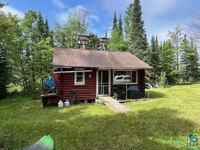 2217 Michael Beach Rd, Zim, MN 55738 - back of house featuring log siding and a yard