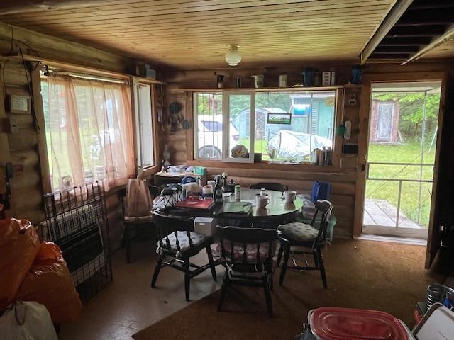 2217 Michael Beach Rd, Zim, MN 55738 - dining room with wood ceiling and rustic walls