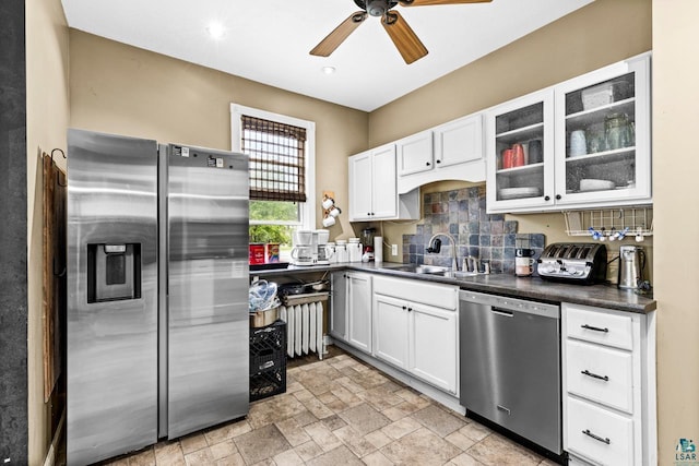 3801 W 5th St, Duluth, MN 55807 - kitchen with stainless steel appliances, dark countertops, ceiling fan, white cabinetry, and glass insert cabinets