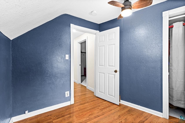3801 W 5th St, Duluth, MN 55807 - additional living space with a ceiling fan, a textured wall, wood finished floors, and vaulted ceiling