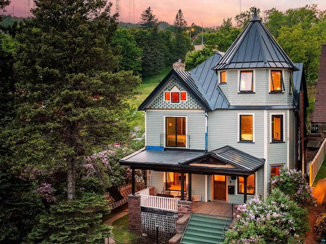31 W 5th St, Duluth, MN 55806 - view of front of home with a standing seam roof, a porch, a metal roof, and a chimney