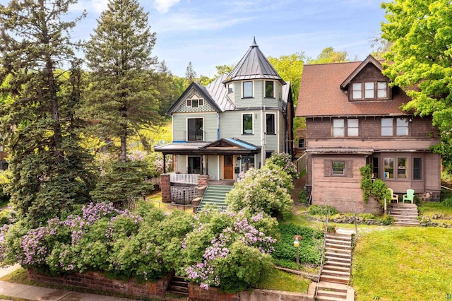 31 W 5th St, Duluth, MN 55806 - victorian house with stairs, a standing seam roof, covered porch, a metal roof, and a front lawn