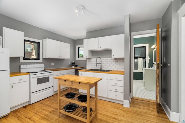 31 W 5th St, Duluth, MN 55806 - kitchen with white appliances, butcher block counters, light wood finished floors, and white cabinets