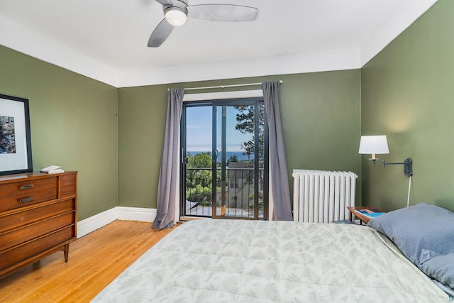 31 W 5th St, Duluth, MN 55806 - bedroom with radiator heating unit, wood finished floors, access to exterior, and ceiling fan