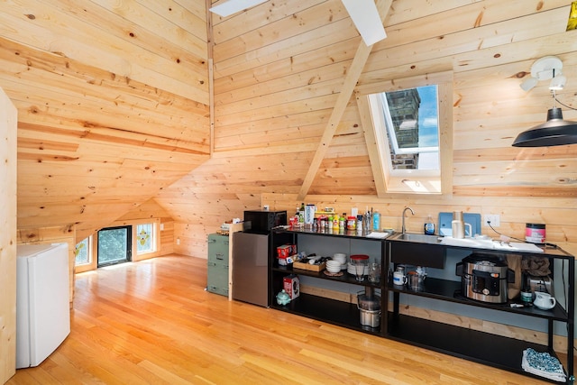 31 W 5th St, Duluth, MN 55806 - additional living space with wood walls, wood finished floors, and washer / dryer