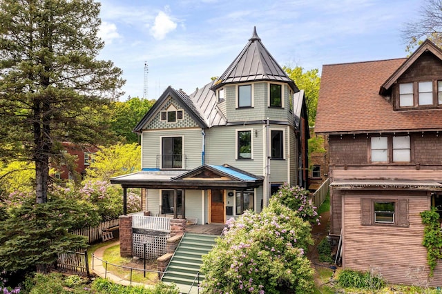 31 W 5th St, Duluth, MN 55806 - victorian home with a standing seam roof, a porch, a metal roof, and stairs