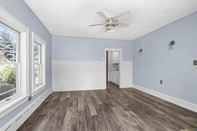 996 85th Ave W, Duluth, MN 55808 - empty room with baseboard heating, ceiling fan, and dark wood-style floors