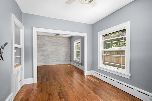 996 85th Ave W, Duluth, MN 55808 - spare room featuring baseboard heating, wood finished floors, and a ceiling fan