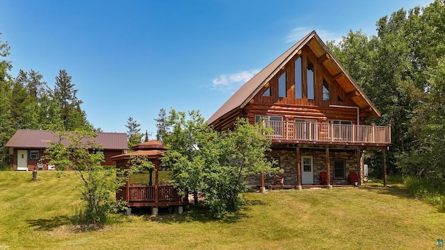 2338 Olson Rd, Carlton, MN 55718 - back of property with a gazebo, a lawn, a deck, stone siding, and a metal roof