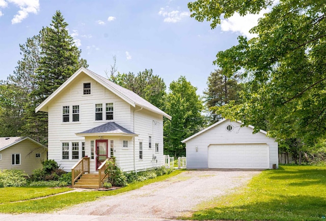 224 W Faribault St, Duluth, MN 55803 - view of front of house featuring an outbuilding, a front lawn, a detached garage, and a shingled roof