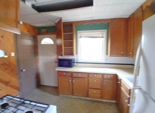 112 W 3rd Ave N, Aurora, MN 55705 - kitchen featuring freestanding refrigerator, brown cabinets, and light countertops