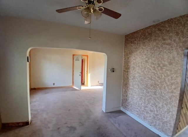 112 W 3rd Ave N, Aurora, MN 55705 - unfurnished room with arched walkways, a ceiling fan, and carpet floors