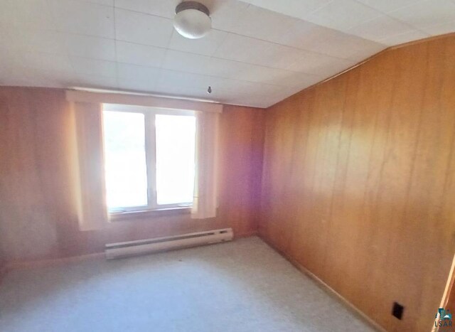 112 W 3rd Ave N, Aurora, MN 55705 - spare room with baseboard heating, wooden walls, and light colored carpet