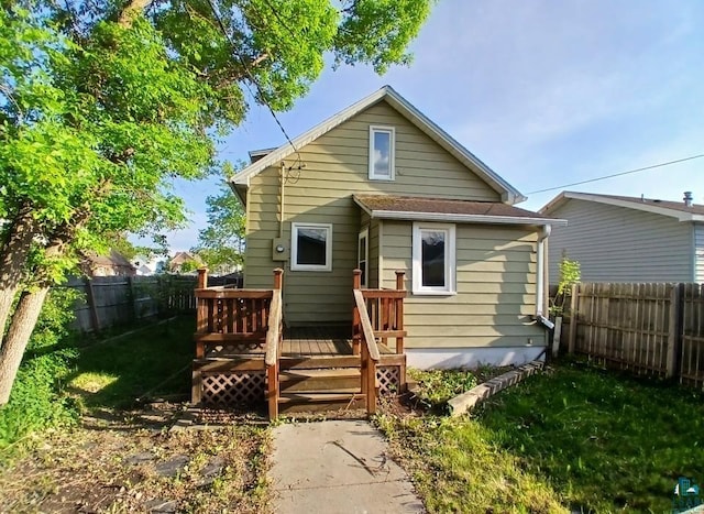 112 W 3rd Ave N, Aurora, MN 55705 - rear view of house with a wooden deck and a fenced backyard