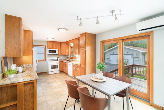 318 Marshall St, Duluth, MN 55803 - kitchen with white appliances, an AC wall unit, and light stone countertops