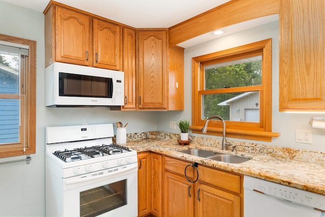 318 Marshall St, Duluth, MN 55803 - kitchen featuring white appliances, healthy amount of natural light, and light stone countertops