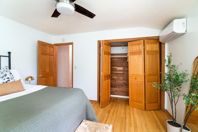 318 Marshall St, Duluth, MN 55803 - bedroom with a wall unit AC, light wood-style floors, a ceiling fan, and a closet