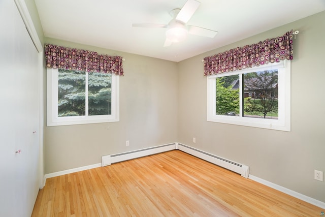 318 Marshall St, Duluth, MN 55803 - spare room with light wood-type flooring, a baseboard heating unit, and ceiling fan
