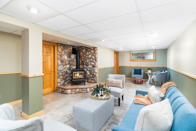 318 Marshall St, Duluth, MN 55803 - living room featuring a wood stove, a paneled ceiling, recessed lighting, and light tile patterned floors