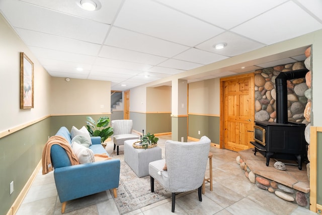 318 Marshall St, Duluth, MN 55803 - living room featuring a wood stove and a paneled ceiling