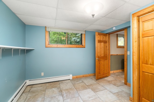 318 Marshall St, Duluth, MN 55803 - empty room featuring baseboard heating, a drop ceiling, and a smoke detector