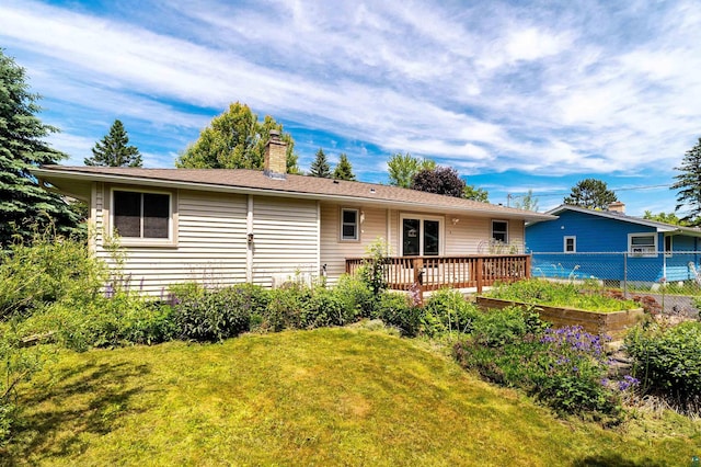 318 Marshall St, Duluth, MN 55803 - back of property featuring a chimney, a lawn, and a wooden deck