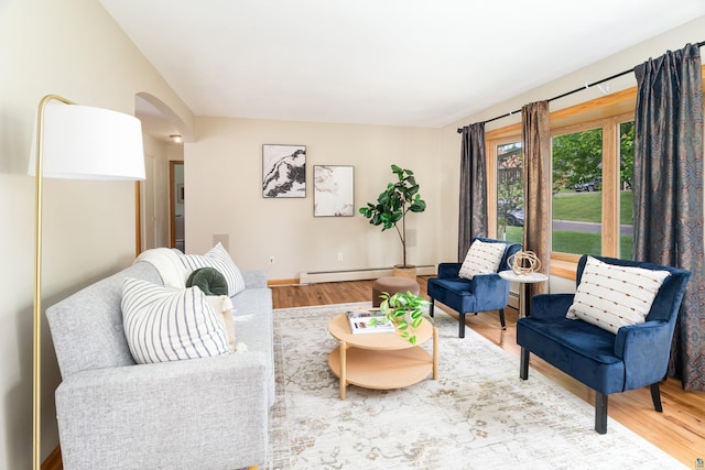 318 Marshall St, Duluth, MN 55803 - living area with arched walkways, wood finished floors, and a baseboard heating unit