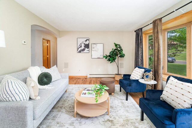 318 Marshall St, Duluth, MN 55803 - living area featuring wood finished floors, arched walkways, and baseboard heating