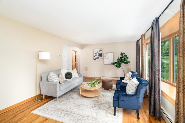 318 Marshall St, Duluth, MN 55803 - living room with baseboard heating, arched walkways, and wood finished floors