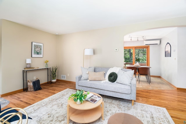 318 Marshall St, Duluth, MN 55803 - living area with wood finished floors and a wall mounted air conditioner
