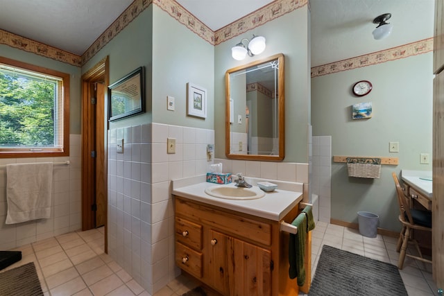 4930 Mini Power Rd, Duluth, MN 55803 - bathroom with tile patterned flooring, tile walls, vanity, wainscoting, and a bath