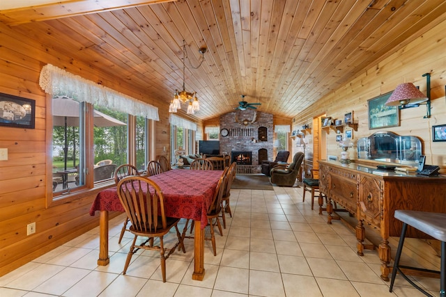 4930 Mini Power Rd, Duluth, MN 55803 - tiled dining room with wooden walls, lofted ceiling, a brick fireplace, a chandelier, and ceiling fan
