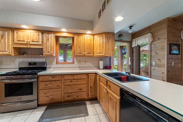 4930 Mini Power Rd, Duluth, MN 55803 - kitchen featuring stainless steel gas range, dishwasher, light tile patterned floors, light countertops, and tasteful backsplash