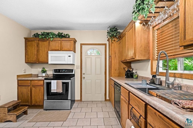 1025 W 3rd St, Duluth, MN 55806 - kitchen with electric range, white microwave, brown cabinets, light countertops, and black dishwasher