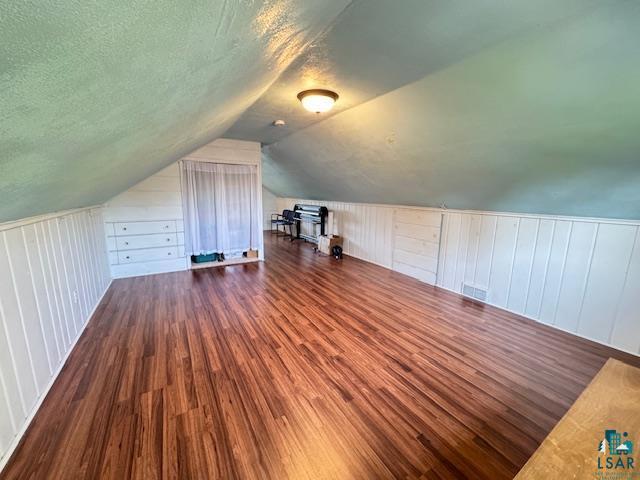 1339 92nd Ave W, Duluth, MN 55808 - bonus room featuring wood finished floors, lofted ceiling, and a textured ceiling