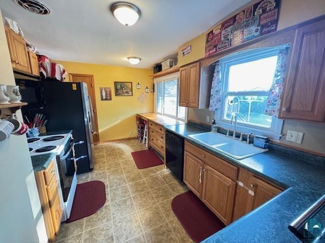 1339 92nd Ave W, Duluth, MN 55808 - kitchen with black dishwasher, electric stove, and brown cabinets