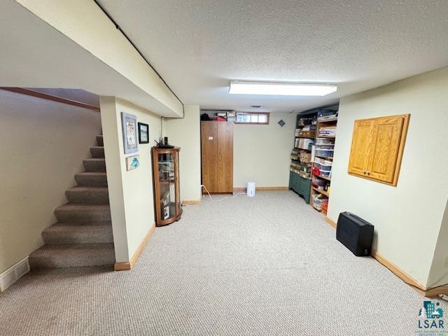 1339 92nd Ave W, Duluth, MN 55808 - basement featuring light carpet, stairway, and a textured ceiling