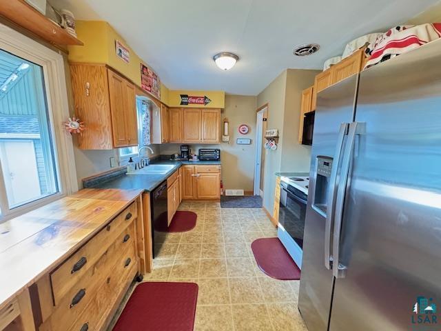 1339 92nd Ave W, Duluth, MN 55808 - kitchen featuring stainless steel refrigerator with ice dispenser, white electric range oven, dishwasher, light tile patterned flooring, and light countertops
