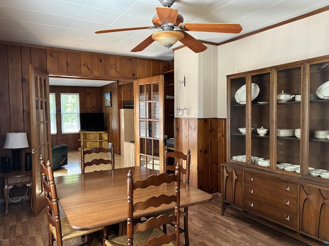 9235 Meadow St, Duluth, MN 55810 - dining space featuring wood walls, a ceiling fan, wood finished floors, and crown molding