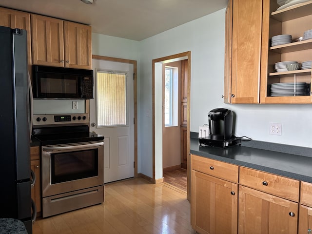 9235 Meadow St, Duluth, MN 55810 - kitchen with black appliances, dark countertops, light wood-style flooring, and open shelves
