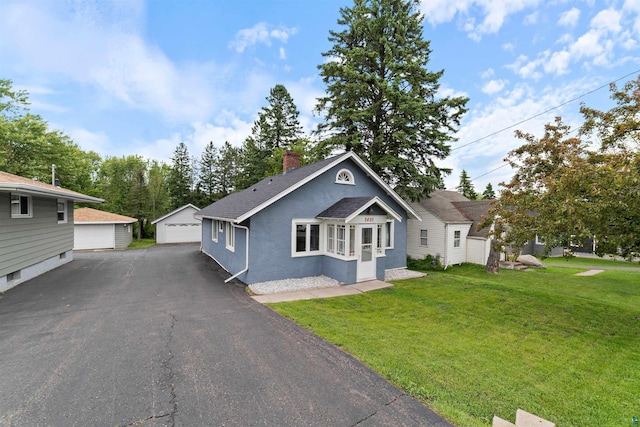 2420 Piedmont Ave, Duluth, MN 55811 - view of front of home with an outdoor structure, a chimney, a garage, a shingled roof, and stucco siding