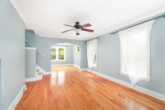 41 Cato Ave, Duluth, MN 55808 - unfurnished room featuring crown molding, stairs, a ceiling fan, arched walkways, and wood finished floors