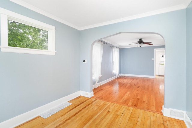 41 Cato Ave, Duluth, MN 55808 - empty room featuring arched walkways, ornamental molding, light wood-style flooring, and ceiling fan
