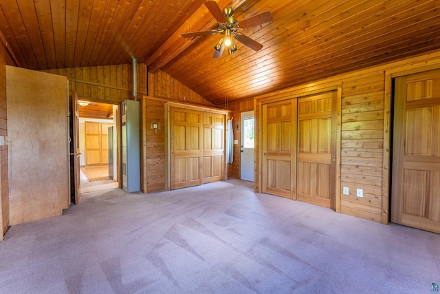 1475 Echo Trl, Ely, MN 55731 - unfurnished bedroom featuring wood walls, carpet flooring, multiple closets, wood ceiling, and ceiling fan