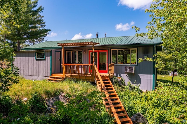 1475 Echo Trl, Ely, MN 55731 - view of front facade featuring a deck, a metal roof, stairs, a wall mounted air conditioner, and a pergola