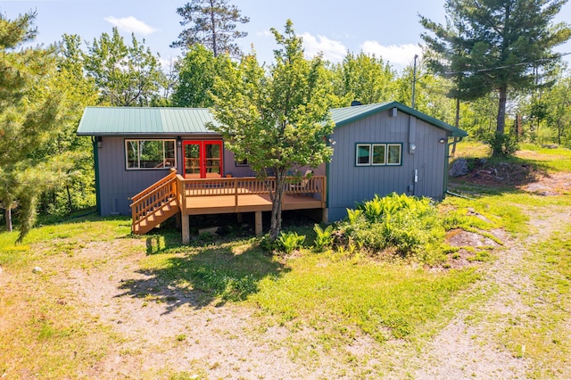 1475 Echo Trl, Ely, MN 55731 - view of front of home featuring a wooden deck, a metal roof, and french doors