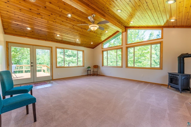 1475 Echo Trl, Ely, MN 55731 - unfurnished living room with a wood ceiling with exposed beams, a wood stove, ceiling fan, carpet, and recessed lighting