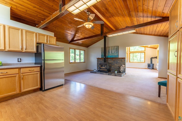 1475 Echo Trl, Ely, MN 55731 - kitchen with a wood stove, freestanding refrigerator, wooden ceiling, a ceiling fan, and open floor plan