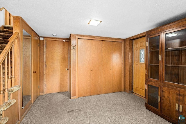 5525 Highland St, Duluth, MN 55807 - hall with carpet floors, stairway, and a textured ceiling