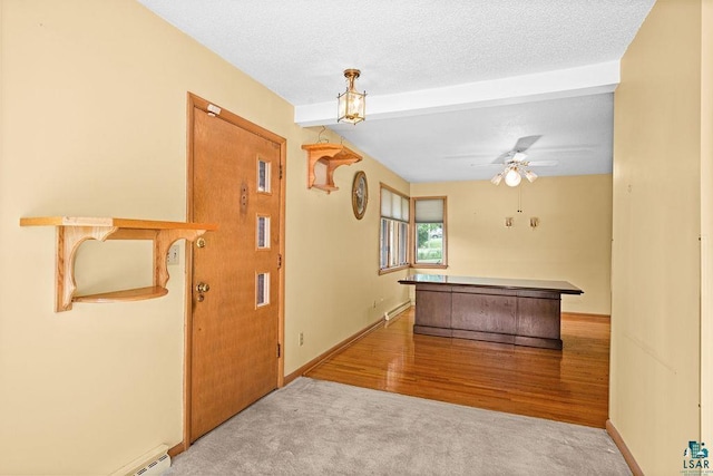5525 Highland St, Duluth, MN 55807 - hallway with carpet, beam ceiling, a baseboard heating unit, and wood finished floors